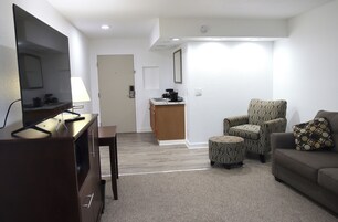 Luxury Suite, 1 King Bed with Sofa bed, Kitchenette | Living area | 55-inch Smart TV with cable channels