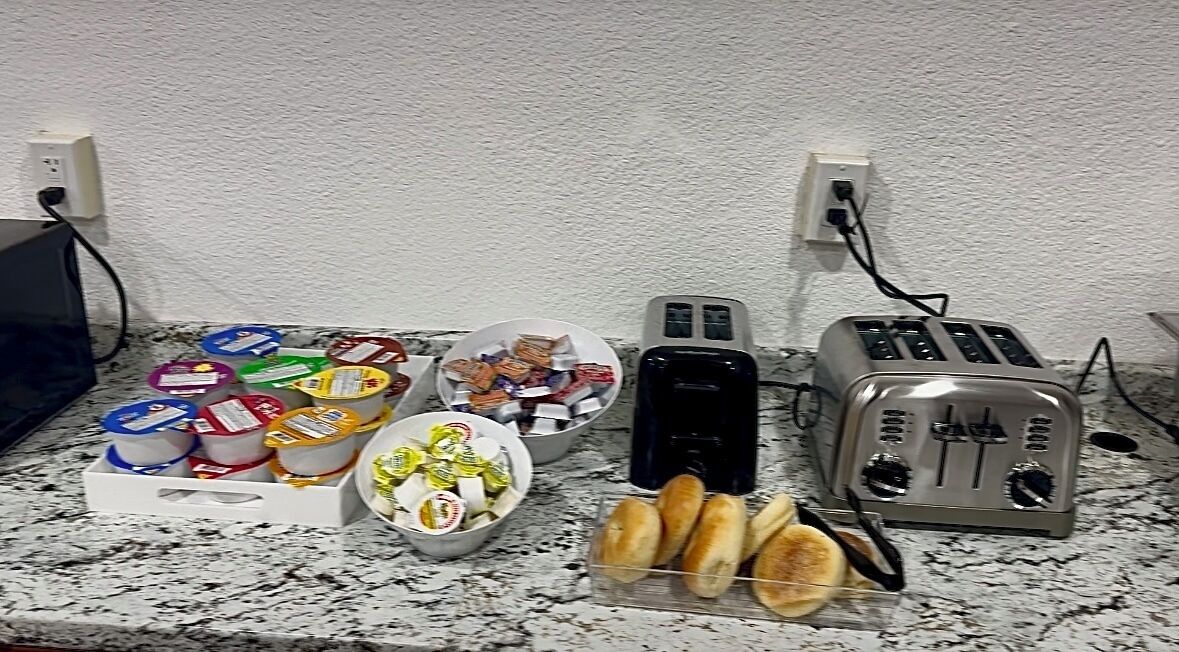 A kitchen counter with various food items, a toaster, and a blender.