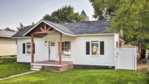 A single-story house with a porch, a small deck, and a garage. - Cheerful 3 bedroom Villa with Backyard Oasis (Spokane)