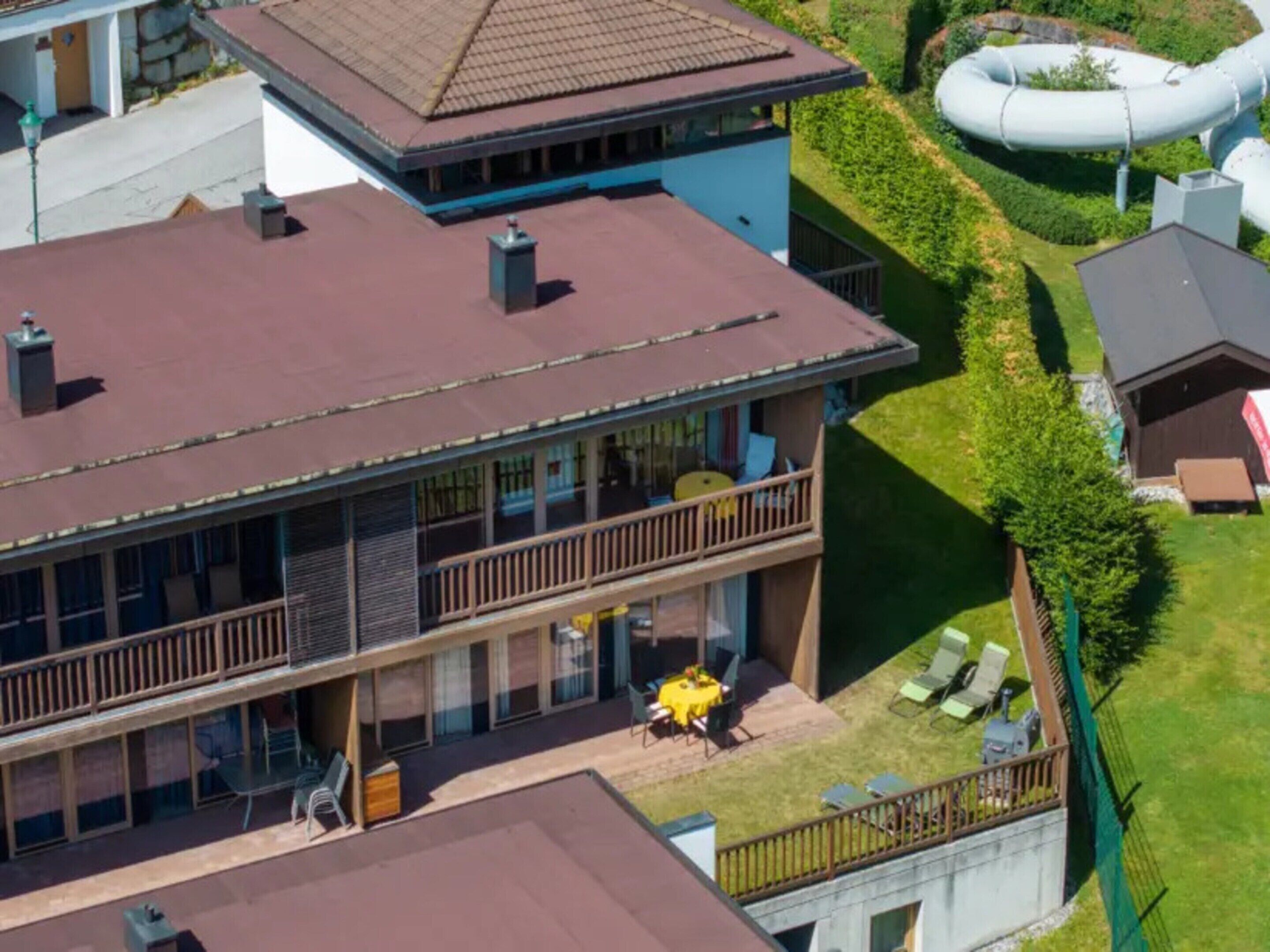 A two-story building with a balcony and a swimming pool.