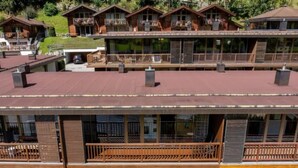 A multi-story hotel with balconies, outdoor seating, and a view of the surrounding landscape. - Maisonette Stay for 8 Guests (Wald im Pinzgau)