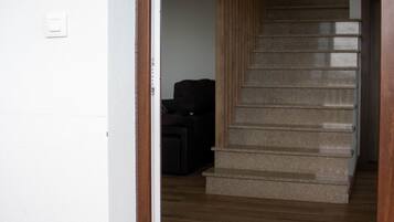 A staircase with wooden steps and a carpeted landing.