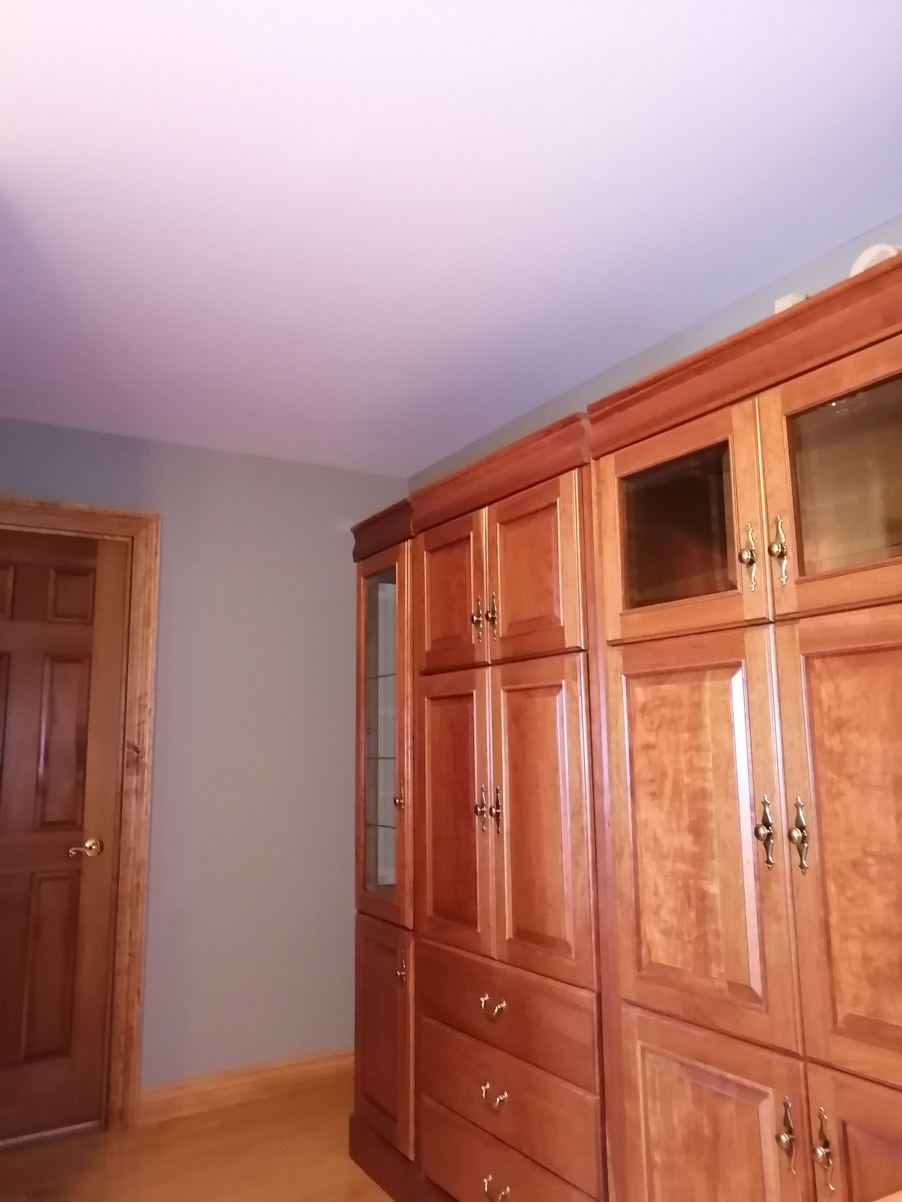 A room with wooden cabinets and a door.