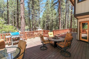 Enjoy al fresco dining on the deck, surrounded by the serene forest views and equipped with a barbecue grill.