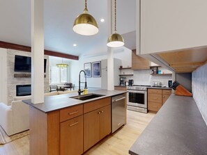 Enjoy cooking in this well-equipped kitchen with an oven, dishwasher, and coffee station.