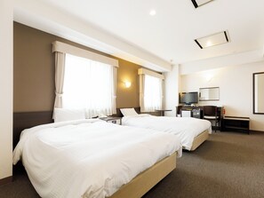 A hotel room with two beds, a desk with a TV, and a small seating area. - TABIST ASAHIKAWA STATION HOTEL (Asahikawa)