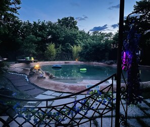 A pool with a wooden deck, surrounded by lush greenery and a stone wall. - La Douce Coulée with an on-site pool (2.5 km from the village) (LORGUES)