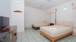 A hotel room with a bed, a TV, a ceiling fan, and a tiled floor. - Hotel del profe (Santa María Huatulco)