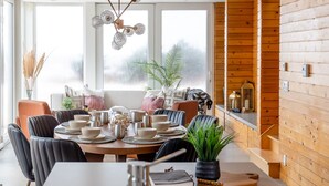 A modern kitchen with a central island, stainless steel appliances, and wooden accents.