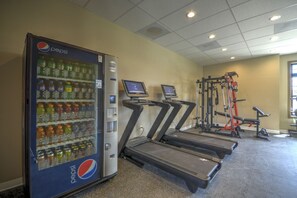 A fitness area with treadmills, a weight machine, and a Pepsi vending machine. - Private hot tub, close to downtown, close to ski mountain (Red Lodge)
