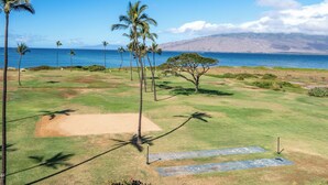 A golf course with a clear view of the ocean and mountains in the background. - Hip Hawaiian Seaside Vistas (Kihei)