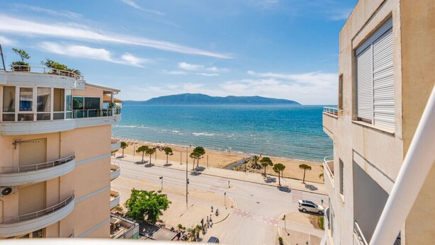A coastal view from a balcony overlooking a beach and the sea. - Kondo Stays - Bliss Apartment (Vlorë)
