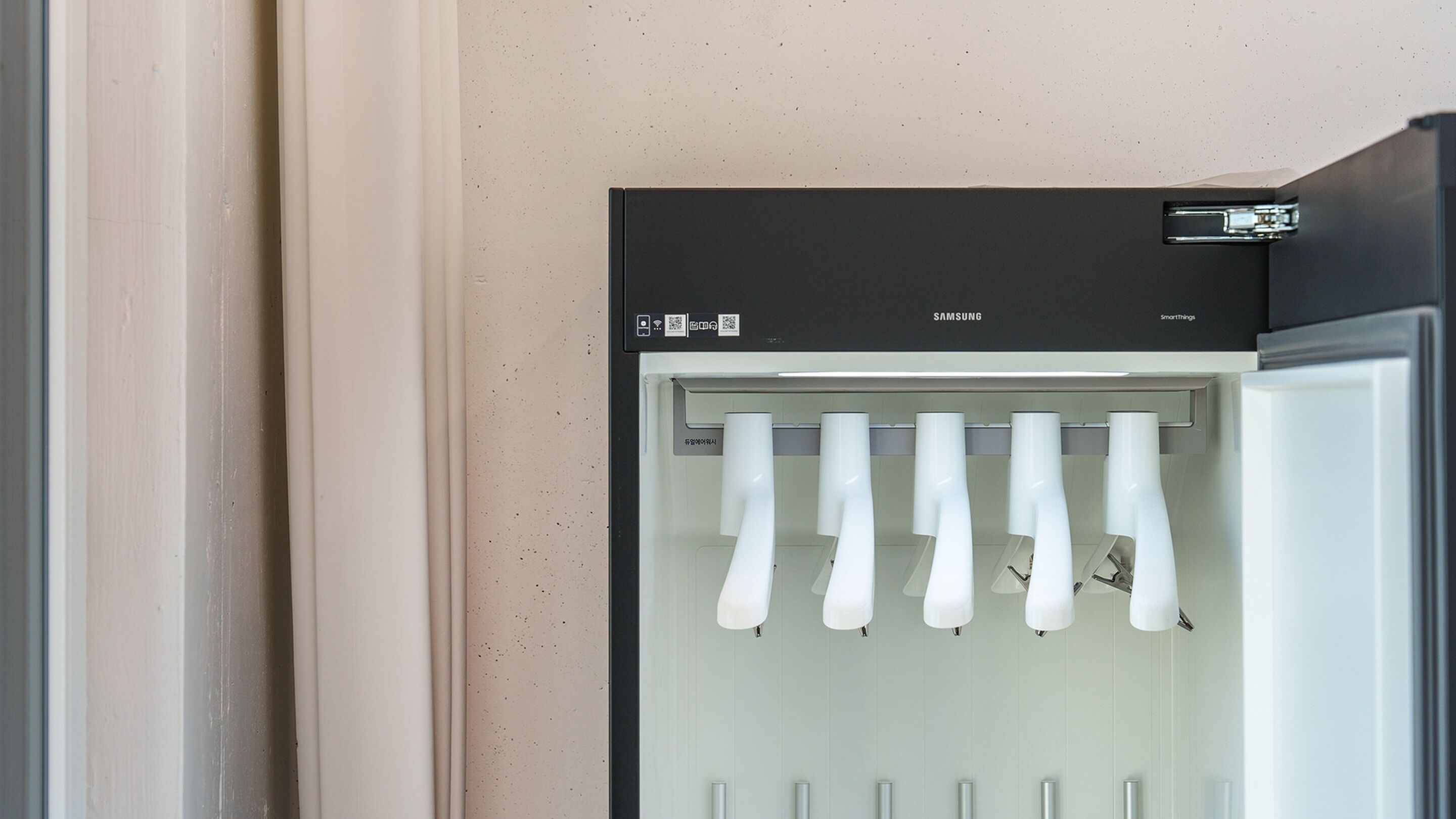 A Samsung refrigerator with multiple bottles of water.