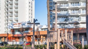 A playground with a slide and climbing structures, surrounded by a building labeled 'Porta Mare Active & Spa Resort.' - Mistral Porta Mare by Interhome (Dziwnówek)