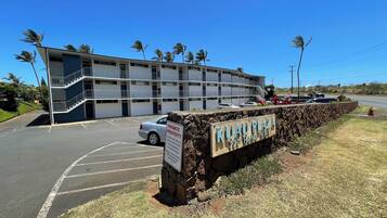 A multi-story building with a parking lot and a sign indicating it is private property.