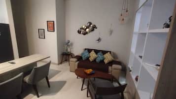 Suite estudio, vista a la ciudad | Área de sala de estar