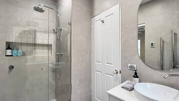 Shower, hair dryer, towels, toilet paper