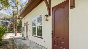 A house with a brown front door, a window, and a mailbox. - American Beach Retreat - Hosted by Moore AI Rentals (Fernandina Beach)