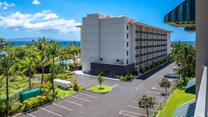 Un hotel de varios pisos con estacionamiento y vistas al océano.