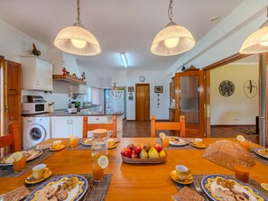 Enjoy breakfast at the large dining table in this well-appointed space.