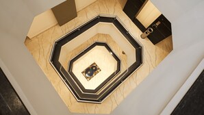 A spiral staircase with a geometric design and a central decorative element. - Arjun - A boutique hotel (Haridwar)