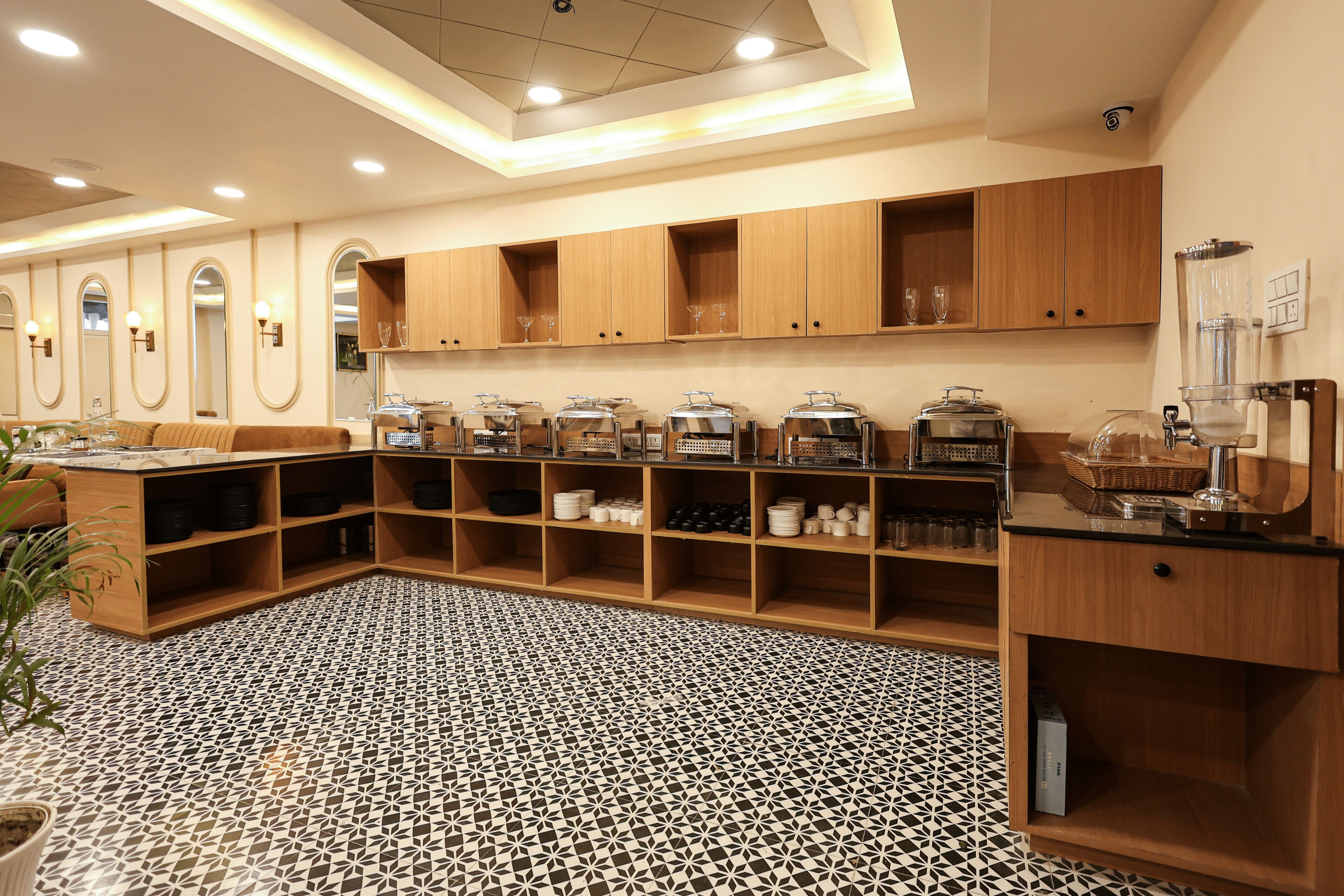 A modern kitchen with wooden cabinets, a tiled floor, and various kitchen appliances.