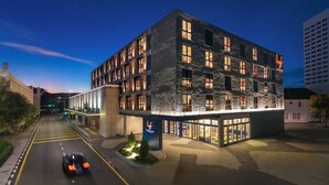 A modern hotel with a stone facade, multiple floors, and a well-lit entrance. - lyf Georgetown Penang (George Town)