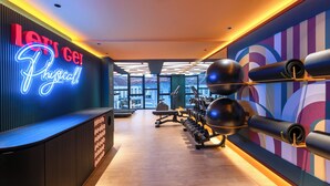 A modern gym with a neon sign, exercise equipment, and large windows. - lyf Georgetown Penang (George Town)