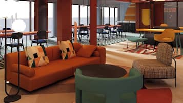 A modern lounge area with a sofa, chairs, and tables.