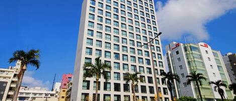 A multi-story hotel with a grid of windows and a flat roof.