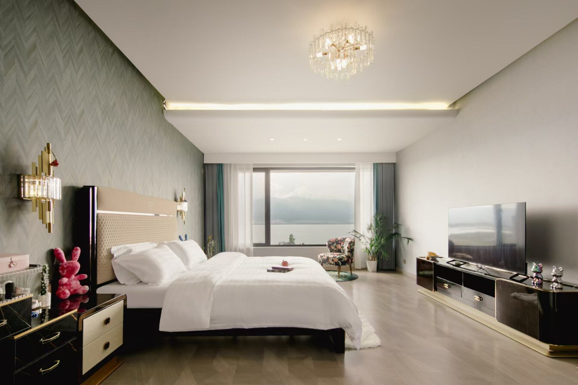A modern bedroom with a large bed, a TV, and a view of the outdoors.