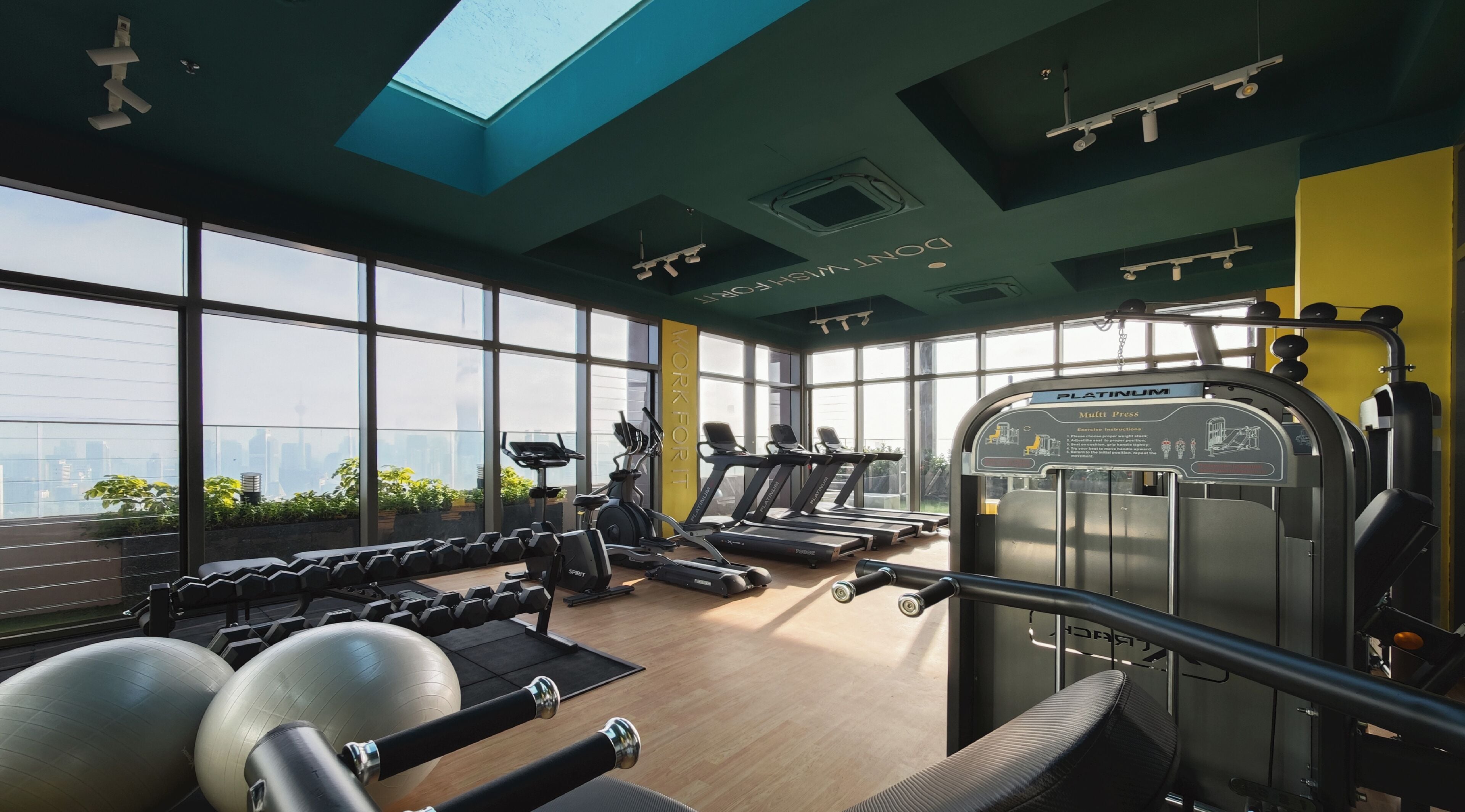 Ein Fitnessstudio mit Laufbändern, Kurzhanteln und Gymbällen.