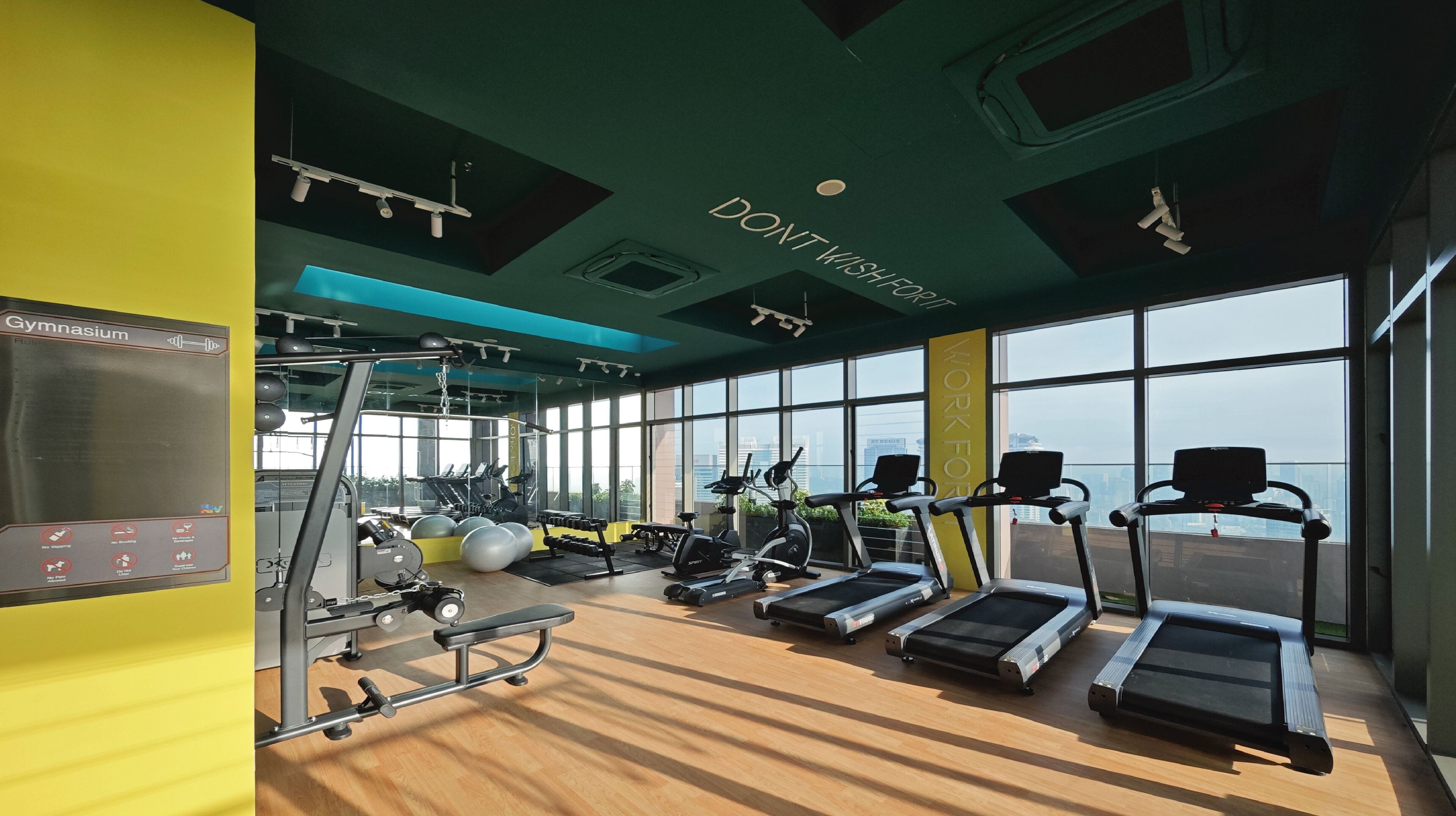 A gym with treadmills, exercise balls, and weight machines.