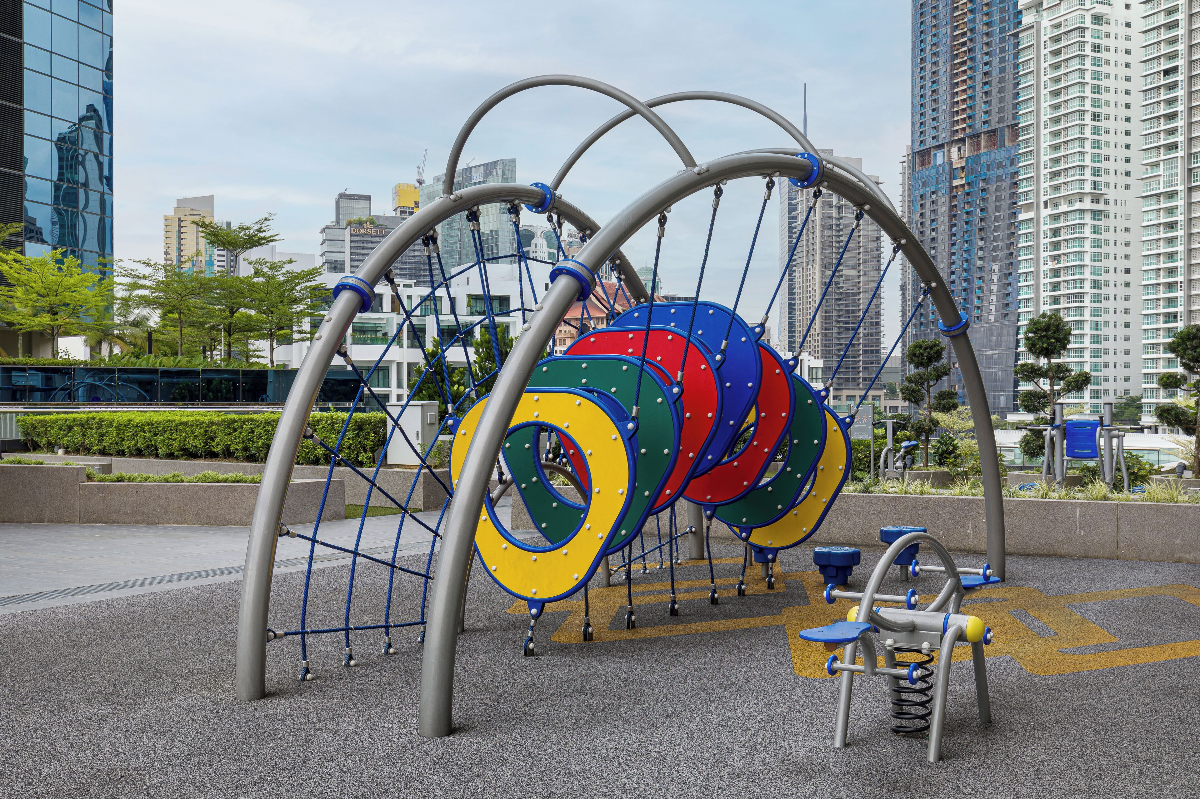 A playground with a climbing structure and exercise equipment.