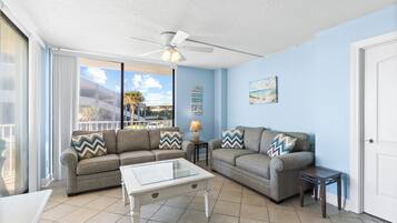 Signature Condo, 2 Bedrooms, Balcony, Pool View | Living room | 48-inch Smart TV with cable channels, DVD player