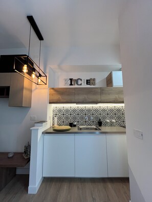 Fridge, microwave, stovetop, coffee/tea maker