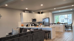 A modern kitchen with white cabinets, stainless steel appliances, and a central island. - NEAR OREGON COAST and FORT STEVENS!!!
HOT TUB-RIVER VIEW-CARGO SHIPS-REC ROOM (Warrenton)