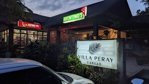 A storefront with a pizza restaurant named 'AVENTINO'S' and a sign for 'VILLA PERAY SIARGAO'. - Villa Peray Siargao (General Luna)