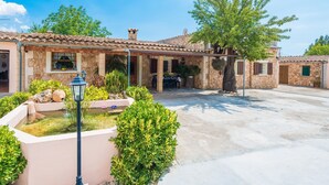 A stone building with a tiled roof, a covered patio, and a small water feature. - Can Tomeu - Villa With Private Pool In Inca (Inca, Illes Balears)