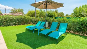 A patio with four blue lounge chairs and a large beige umbrella. - Can Tomeu - Villa With Private Pool In Inca (Inca, Illes Balears)
