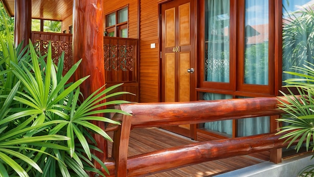 A wooden building with a porch, a wooden door with a number, and a window with a curtain. - Chatsuree Boutique Resort (Ubon Ratchathani)