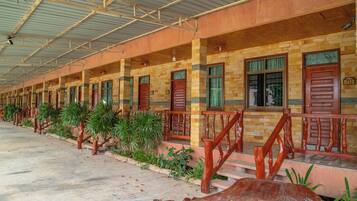 A row of rooms with wooden railings and green windows, numbered 501.