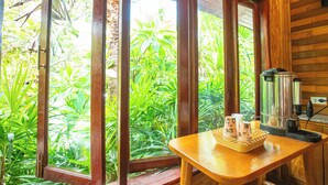 A wooden interior with a window view of lush greenery. - Chatsuree Boutique Resort (Ubon Ratchathani)