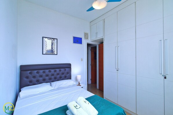 A bedroom with a bed, a wardrobe, and a ceiling fan. - MZapartments Ataulfo Leblon (Rio de Janeiro)