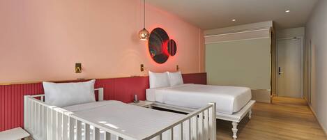 A hotel room with two beds, a bedside table, a wall-mounted light fixture, and a door.