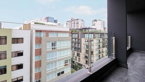 A high-rise building with multiple floors, large windows, and a balcony with a metal railing. - w* | Elegant 2BR w/ Balcony Near Larcomar (Miraflores)