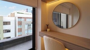A modern bathroom with a large window, a round mirror, and a wooden vanity. - w* | Elegant 2BR w/ Balcony Near Larcomar (Miraflores)