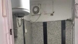 A small, narrow bathroom with a toilet, a sink, and a shower stall. - Gurugram Home Residency (Gurugram)