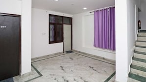 A room with a marble floor, a door labeled '203', a window with purple curtains, and a staircase. - Gurugram Home Residency (Gurugram)