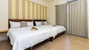 A hotel room with two beds, wooden headboards, white bedding, a wooden floor, a window with curtains, and an air conditioning unit. - Turn Right Home (Wujie)